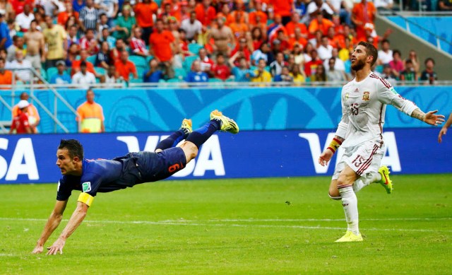 Spain's Ramos reacts as van Persie of the Netherlands scores during their 2014 World Cup Group B soccer match at the Fonte Nova arena in Salvador