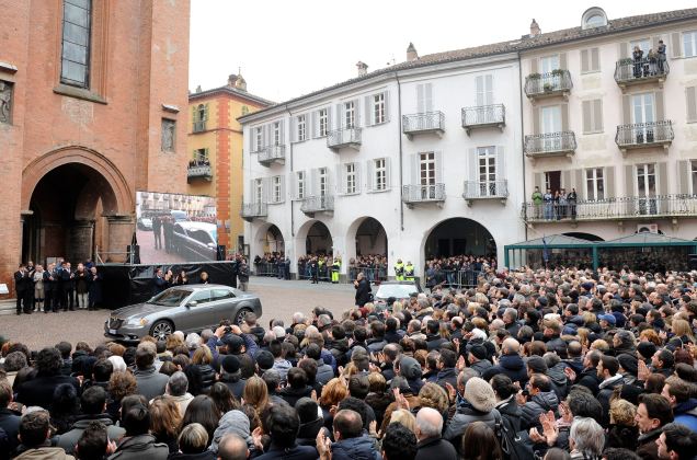 People gather to pay respect during the funeral service of Michele Ferrero in Alba