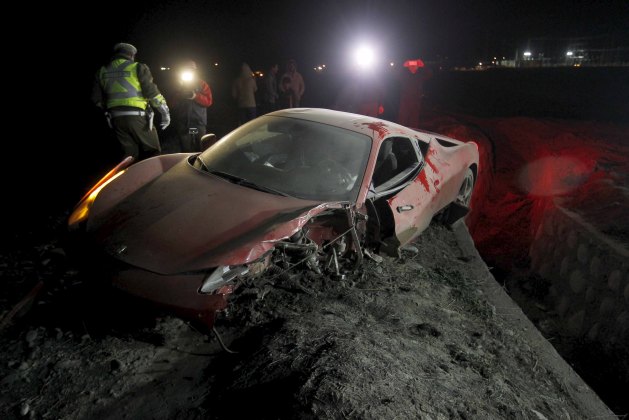 A red Ferrari belonging to Chile's player Arturo Vidal is seen after a car crash on a highway, south of Santiago