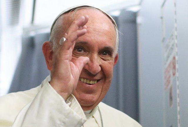 Pope Francis smiles onboard the papal plane during his return to Rome, from Asuncion, Paraguay