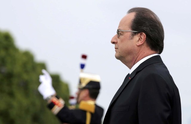 French President Francois Hollande reviews the troops on the Champs Elysees Avenue during the Bastille Day military parade in Paris, France, July 14, 2016.   REUTERS/Thibault Camus/Pool