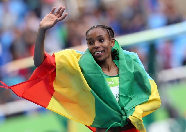 2016 Rio Olympics - Athletics - Final - Women's 10,000m Final - Olympic Stadium - Rio de Janeiro, Brazil - 12/08/2016. Almaz Ayana (ETH) of Ethiopia celebrates after she set a new world record. REUTERS/Alessandro Bianchi FOR EDITORIAL USE ONLY. NOT FOR SALE FOR MARKETING OR ADVERTISING CAMPAIGNS.