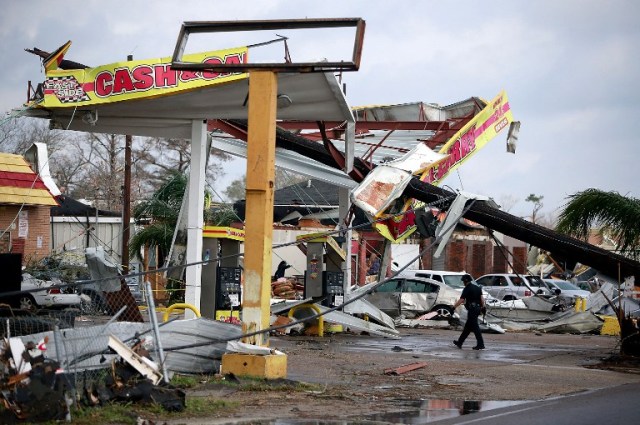 NEW ORLEANS, LA - FEBRUARY 07: A police officer walks through a damaged gas station along Chef Menture Avenue after a tornado touched down in the eastern part of the city on February 7, 2017 in New Orleans, Louisiana. According to the weather service, 25 people were injured in the aftermath of the tornado. Sean Gardner/Getty Images/AFP