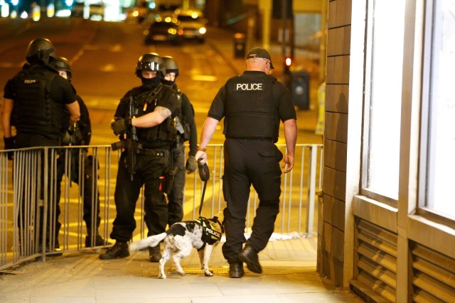 FILE PHOTO: Armed police officers stand near the Manchester Arena, where U.S. singer Ariana Grande had been performing, in Manchester, in northern England, Britain May 23, 2017. REUTERS/Andrew Yates/File Photo