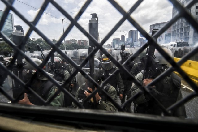 La policía antidisturbios de la Guardia Nacional se mantiene en pie mientras los manifestantes de la oposición se reúnen para protestar en Caracas / AFP PHOTO / JUAN BARRETO