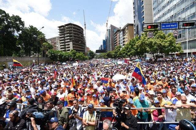 Opposition activists demonstrate against Venezuelan President Nicolas Maduro in Caracas, on July 9, 2017. Venezuela hit its 100th day of anti-government protests on Sunday, one day after its most prominent political prisoner, Leopoldo Lopez, vowed to continue his fight for freedom after being released from jail and placed under house arrest. At least 91 people have died since non-stop street protests began on April 1. / AFP PHOTO / Juan BARRETO