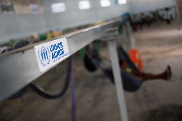 The logo of United Nations refugee agency UNHCR is seen on metal structures they provided and where hammocks hang for members of the indigenous Warao people from the Orinoco Delta in eastern Venezuela, at a shelter in Pacaraima, Roraima state, Brazil November 15, 2017. Picture taken November 15, 2017. REUTERS/Nacho Doce
