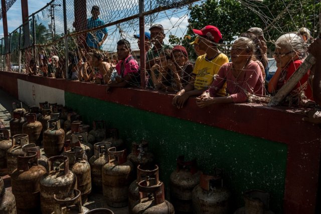 Residentes del pueblo pesquero de Amuay esperaron varias horas para que les llenaran sus tanques de gas. En los últimos años ha empeorado la crisis de la petrolera estatal, lo que amenaza con desestabilizar al país. Credit Meridith Kohut para The New York Times
