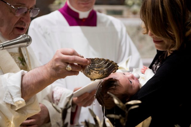 Pope Francis baptises an infant during a solemn mass in the Sistine Chapel at the Vatican January 7, 2018. Osservatore Romano/Handout via REUTERS ATTENTION EDITORS - THIS IMAGE WAS PROVIDED BY A THIRD PARTY.