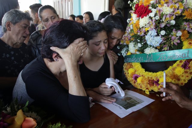 Mourners react next to the coffin of Joel Contreras, who died during clashes between Venezuelan soldiers and illegal miners in Guasipati according to local media, during his funeral at the cemetery in Upata, Venezuela February 12, 2018. REUTERS/William Urdaneta NO RESALES. NO ARCHIVES