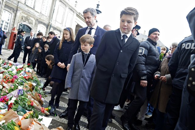 Danish Crown Prince Frederik and Prince Christian look at flowers in front of Amalienborg Palace in Copenhagen, Denmark, February 15, 2018. Ritzau Scanpix Denmark/Mads Claus Rasmussen via REUTERS ATTENTION EDITORS - THIS IMAGE WAS PROVIDED BY A THIRD PARTY. DENMARK OUT. NO COMMERCIAL OR EDITORIAL SALES IN DENMARK.